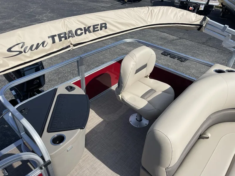 Slide: The Image of 2025 Sun Tracker Bass Buggy 18 DLX pontoon boat interior with beige seating. - 10