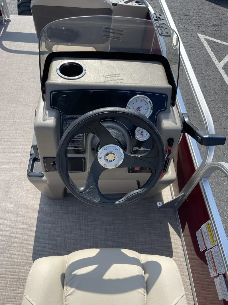 Slide: The Image of 2025 Sun Tracker Bass Buggy 18 DLX steering console with gauges and controls. - 11