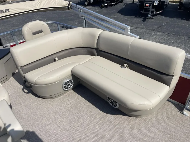 Slide: The Image of 2025 Sun Tracker Bass Buggy 18 DLX pontoon boat seating area, beige upholstery. - 13