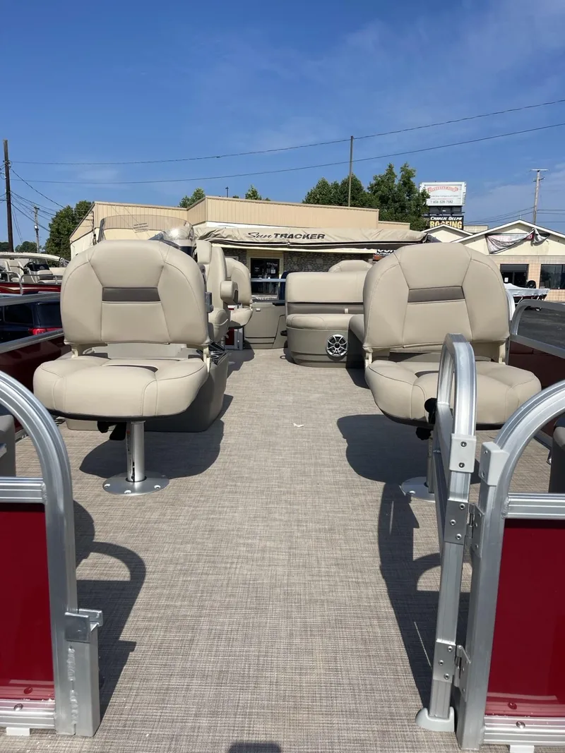 Slide: The Image of 2025 Sun Tracker Bass Buggy 18 DLX pontoon boat with beige seating and red accents. - 4