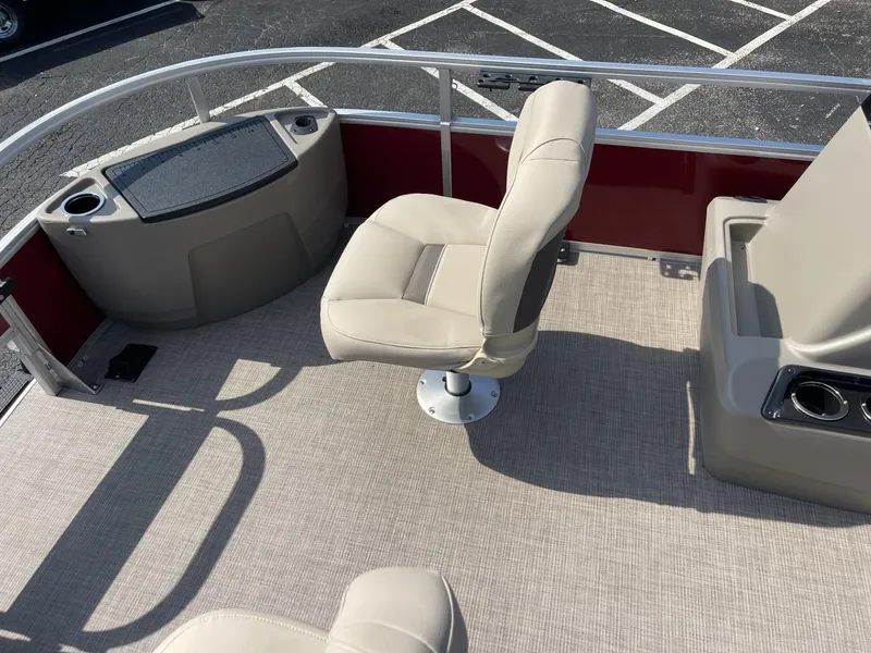 Slide: The Image of 2025 Sun Tracker Bass Buggy 18 DLX boat interior with beige seating and red accents. - 7