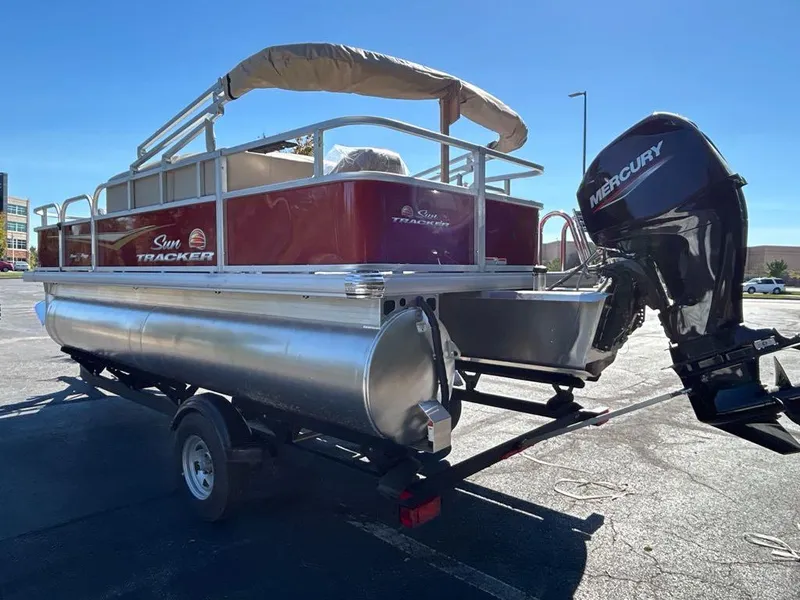 Slide: The Image of 2025 Sun Tracker Bass Buggy 18 DLX pontoon boat with Mercury outboard motor. - 2