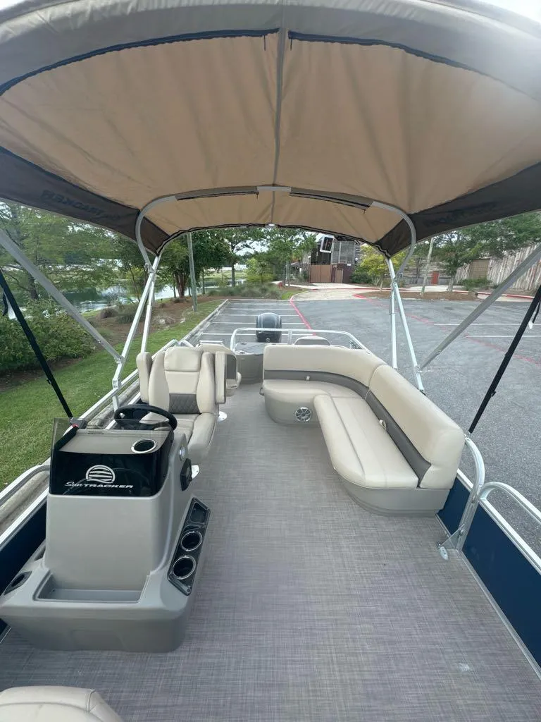 Slide: The Image of 2025 Sun Tracker Bass Buggy 18 DLX pontoon boat with canopy and seating. - 5