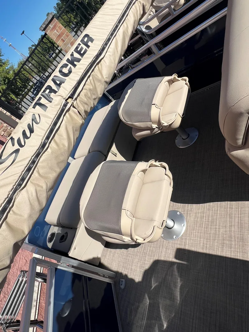 Slide: The Image of 2025 Sun Tracker Fishin' Barge 22 XP3 with beige seating and cover. - 3
