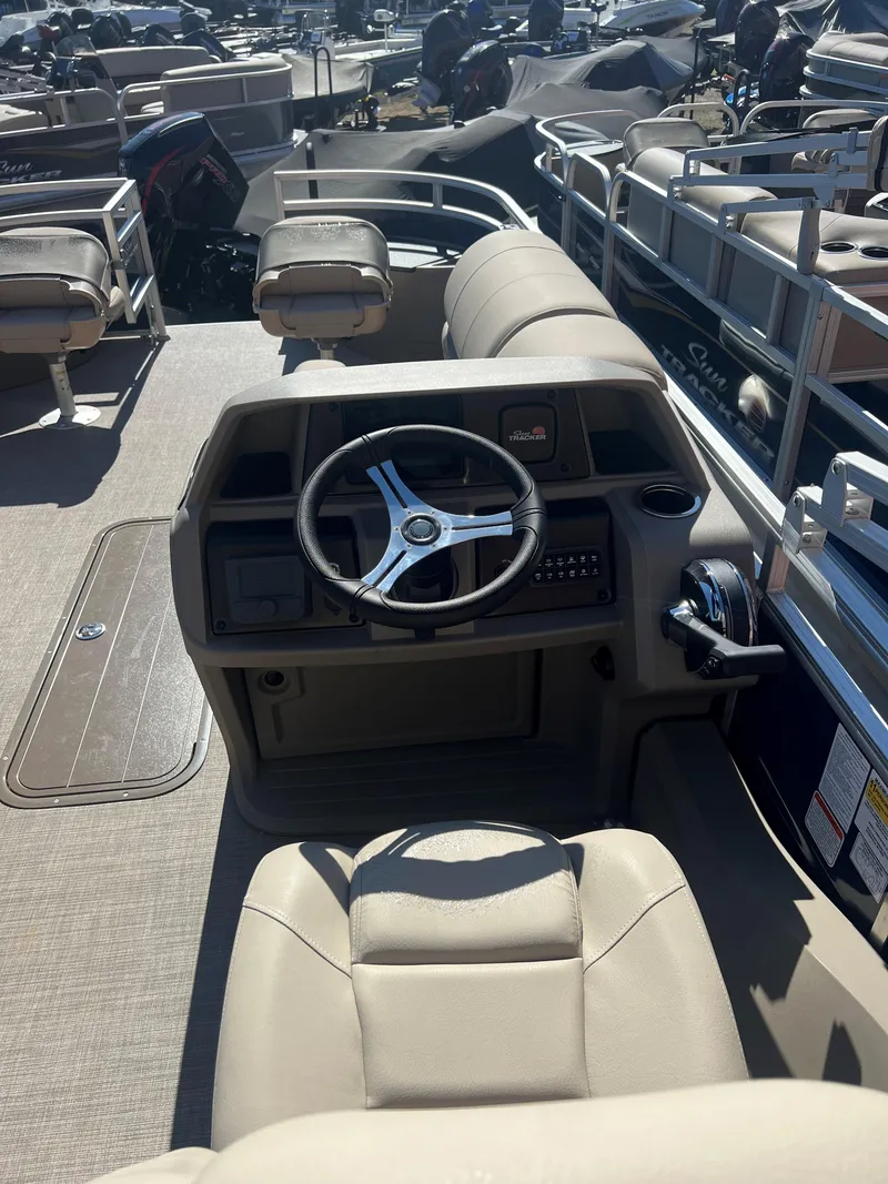 Slide: The Image of 2025 Sun Tracker Fishin' Barge 22 XP3 interior with steering console and seating. - 5