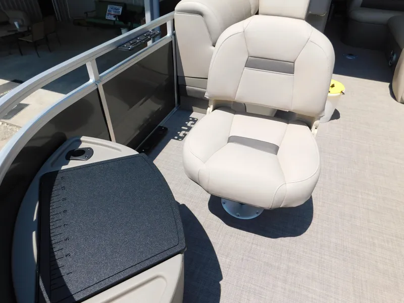 Slide: The Image of 2025 Sun Tracker Fishin' Barge 22 DLX interior with comfortable seating and modern design. - 11