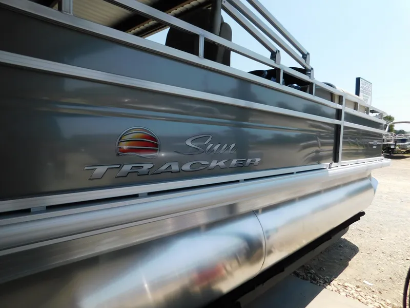 Slide: The Image of 2025 Sun Tracker Fishin' Barge 22 DLX pontoon boat side view. - 2