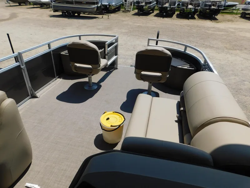 Slide: The Image of 2025 Sun Tracker Fishin' Barge 22 DLX interior with seating and fishing setup. - 32