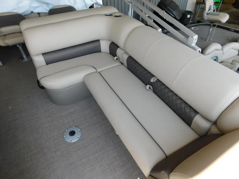 Slide: The Image of 2025 Sun Tracker Fishin' Barge 22 DLX interior seating with beige upholstery. - 8