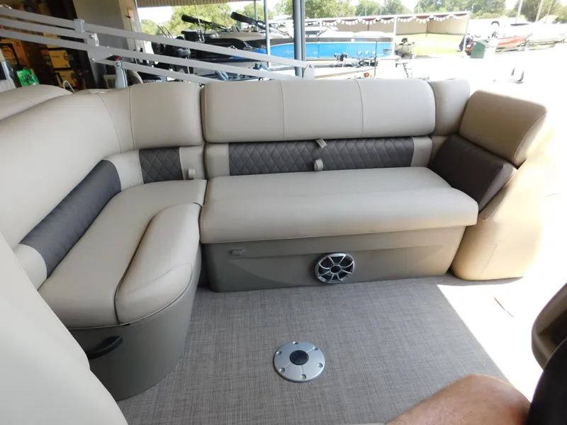 Slide: The Image of 2025 Sun Tracker Fishin' Barge 22 DLX interior seating with beige upholstery. - 9