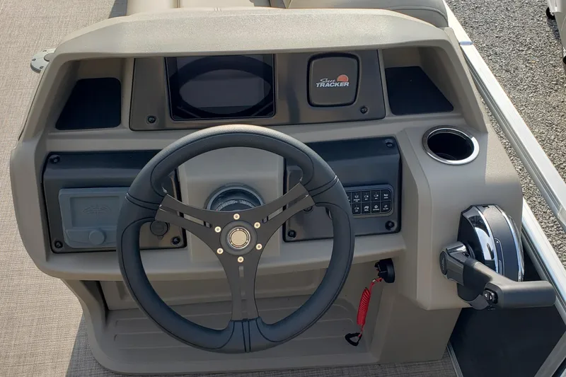 Slide: The Image of 2025 Sun Tracker Party Barge 22 DLX dashboard with steering wheel and controls. - 3