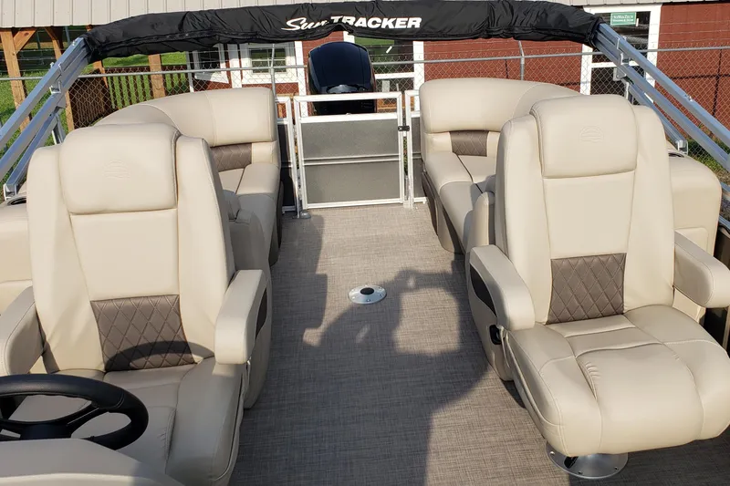 Slide: The Image of 2025 Sun Tracker Party Barge 22 DLX with luxurious beige seating and spacious deck. - 5