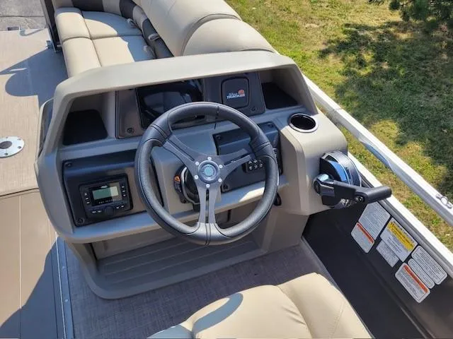 Slide: The Image of 2025 Sun Tracker Party Barge 22 RF XP3 steering console with modern controls and seating. - 3
