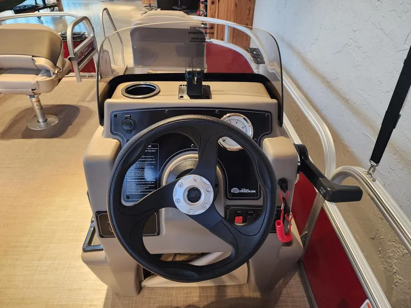 Slide: The Image of 2025 Sun Tracker Bass Buggy 16 XL Select steering console with controls and gauges. - 4