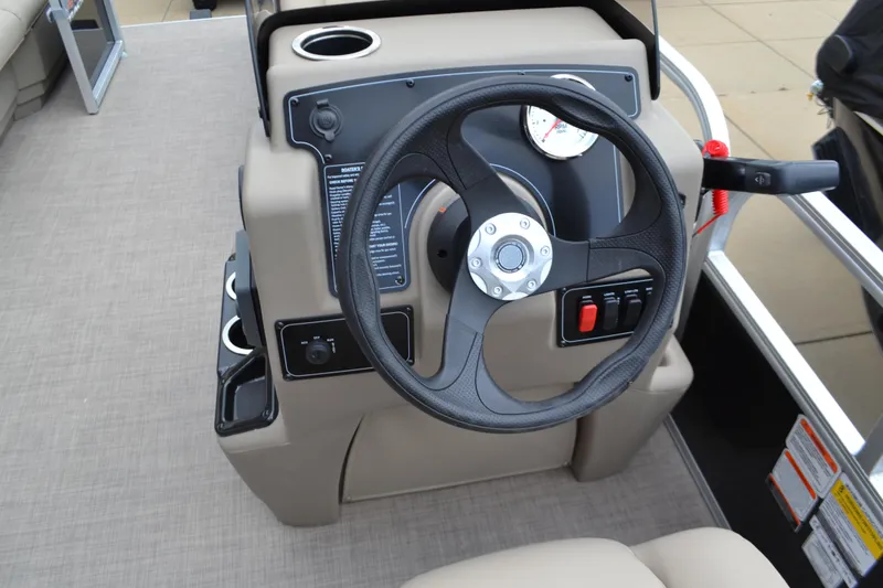 Slide: The Image of 2025 Sun Tracker Party Barge 16 DLX steering console with gauges and controls. - 3