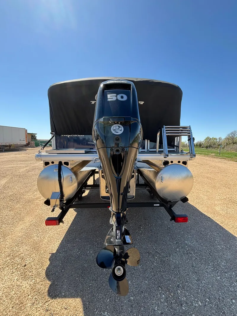 Slide: The Image of 2025 Sun Tracker Bass Buggy 16 XL Select pontoon boat with 50 HP motor, rear view. - 13