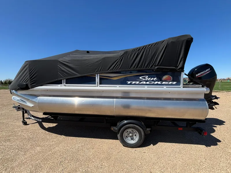 Slide: The Image of 2025 Sun Tracker Bass Buggy 16 XL Select pontoon boat with cover on trailer. - 8