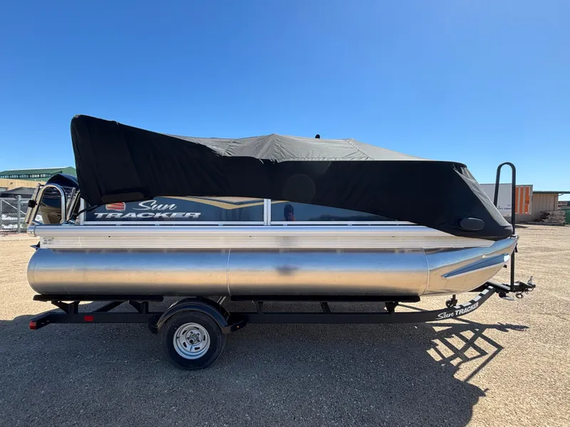 Slide: The Image of 2025 Sun Tracker Bass Buggy 16 XL Select pontoon boat with cover on trailer. - 9