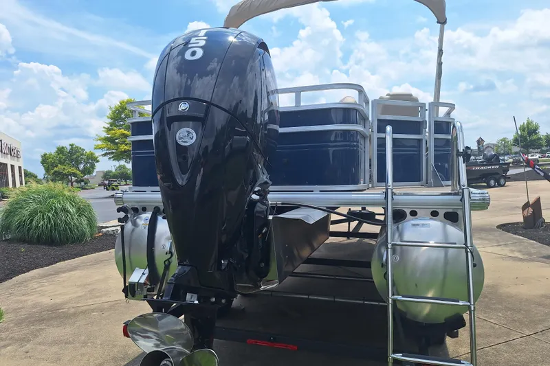 Slide: The Image of 2025 Sun Tracker Fishin' Barge 22 DLX pontoon boat with powerful outboard motor. - 5