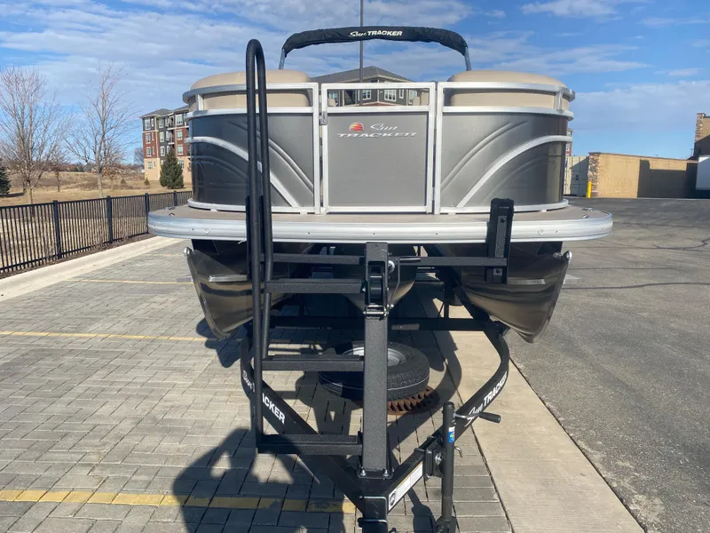 Slide: The Image of 2025 Sun Tracker Party Barge 22 XP3 on trailer in parking lot. - 2