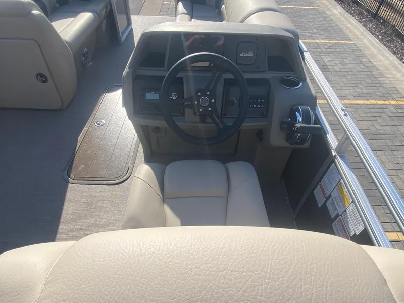 Slide: The Image of 2025 Sun Tracker Party Barge 22 XP3 helm with steering wheel and controls. - 5