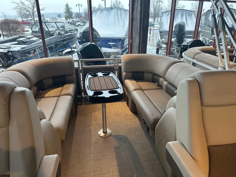 Slide: The Image of 2025 Sun Tracker Party Barge 24 DLX interior with plush seating and central table. - 3