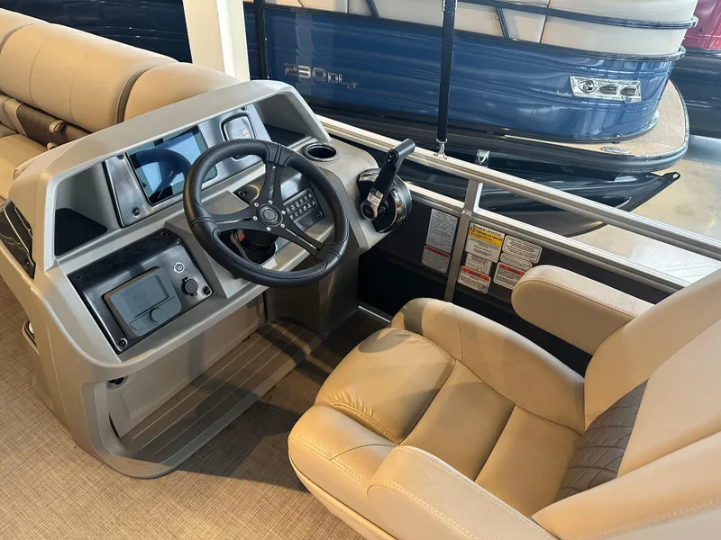 Slide: The Image of 2025 Sun Tracker Party Barge 24 DLX interior with steering console and seating. - 4