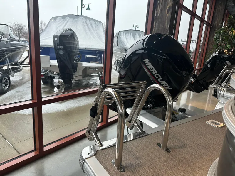 Slide: The Image of 2025 Sun Tracker Party Barge 24 DLX with Mercury engine, displayed indoors. - 5