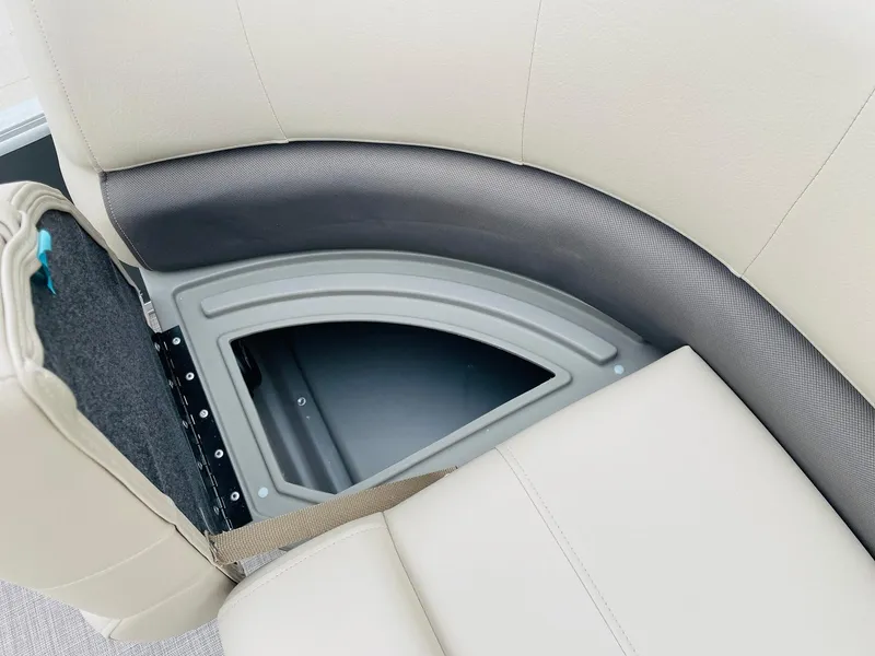 Slide: The Image of 2025 Sun Tracker Party Barge 18 DLX seat storage compartment, beige upholstery. - 14