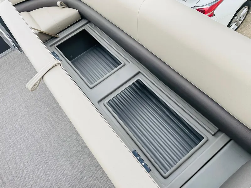 Slide: The Image of 2025 Sun Tracker Party Barge 18 DLX storage compartments with cushioned seating. - 15