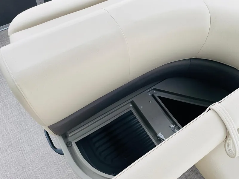 Slide: The Image of 2025 Sun Tracker Party Barge 18 DLX seating with storage compartment open. - 20