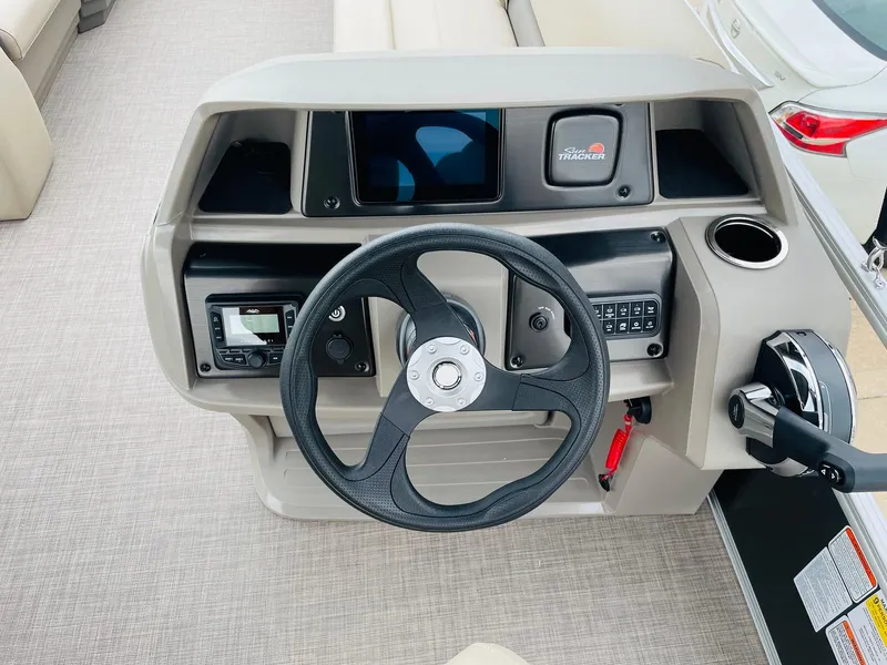 Slide: The Image of 2025 Sun Tracker Party Barge 18 DLX steering console with modern controls and dashboard. - 21