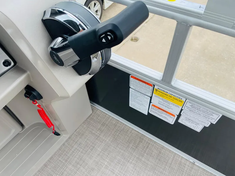 Slide: The Image of Close-up of 2025 Sun Tracker Party Barge 18 DLX throttle control and safety instructions. - 25