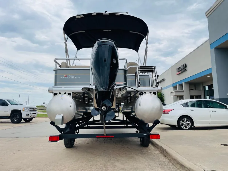 Slide: The Image of 2025 Sun Tracker Party Barge 18 DLX pontoon boat on trailer, rear view. - 6
