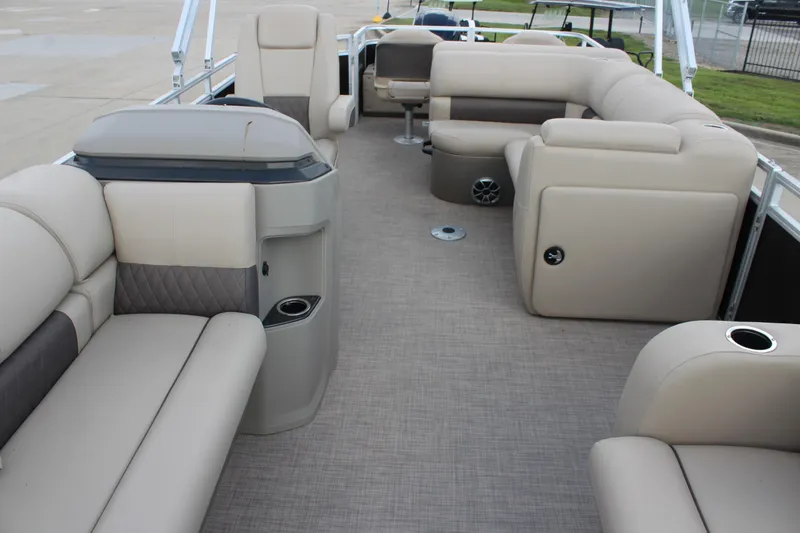 Slide: The Image of 2025 Sun Tracker SportFish 22 DLX interior with beige seating and spacious layout. - 10