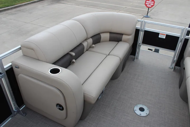 Slide: The Image of 2025 Sun Tracker SportFish 22 DLX pontoon boat with beige seating and cup holder. - 12