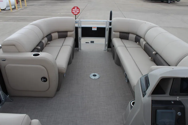 Slide: The Image of 2025 Sun Tracker SportFish 22 DLX pontoon boat interior with beige seating and spacious layout. - 13