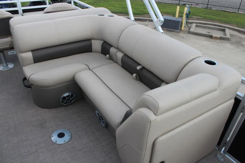 Slide: The Image of Luxurious seating on 2025 Sun Tracker SportFish 22 DLX pontoon boat, featuring cup holders and speakers. - 16