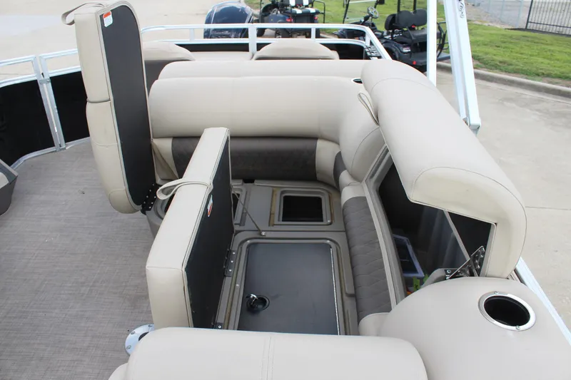 Slide: The Image of 2025 Sun Tracker SportFish 22 DLX interior with beige seating and storage compartments. - 18