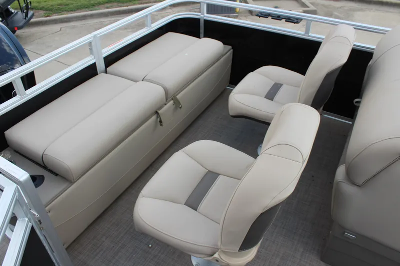 Slide: The Image of 2025 Sun Tracker SportFish 22 DLX interior with beige seating and spacious layout. - 19