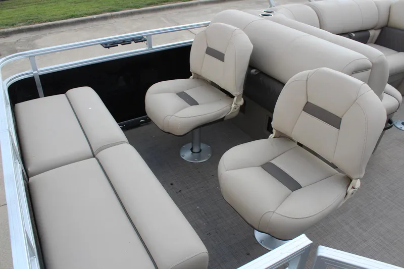 Slide: The Image of 2025 Sun Tracker SportFish 22 DLX interior with beige seating and fishing chairs. - 22