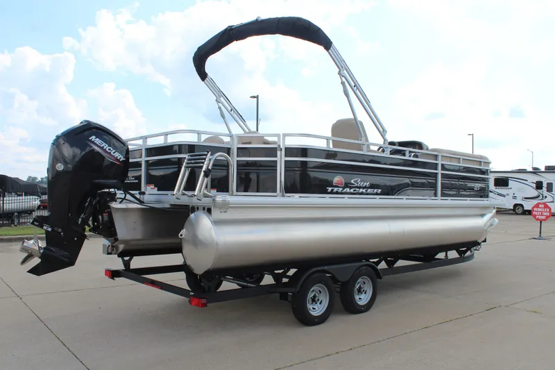 Slide: The Image of 2025 Sun Tracker SportFish 22 DLX pontoon boat on trailer, featuring Mercury outboard motor. - 6