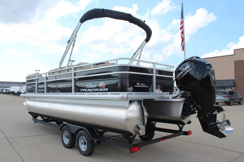 Slide: The Image of 2025 Sun Tracker SportFish 22 DLX pontoon boat on trailer, outdoor display. - 8