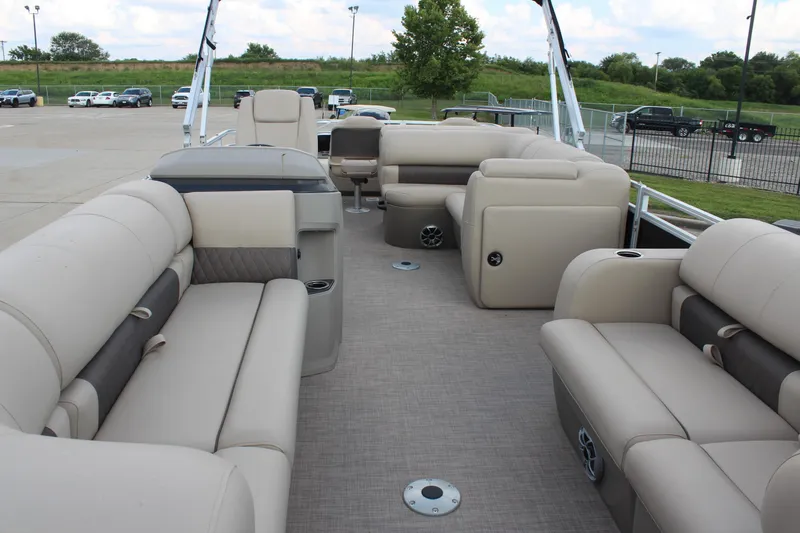 Slide: The Image of 2025 Sun Tracker SportFish 22 DLX pontoon boat with spacious beige seating and modern design. - 9