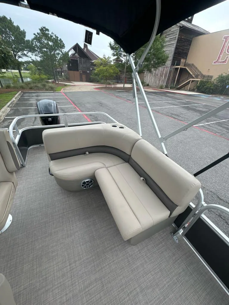 Slide: The Image of 2025 Sun Tracker Party Barge 18 DLX with beige seating and spacious deck. - 5