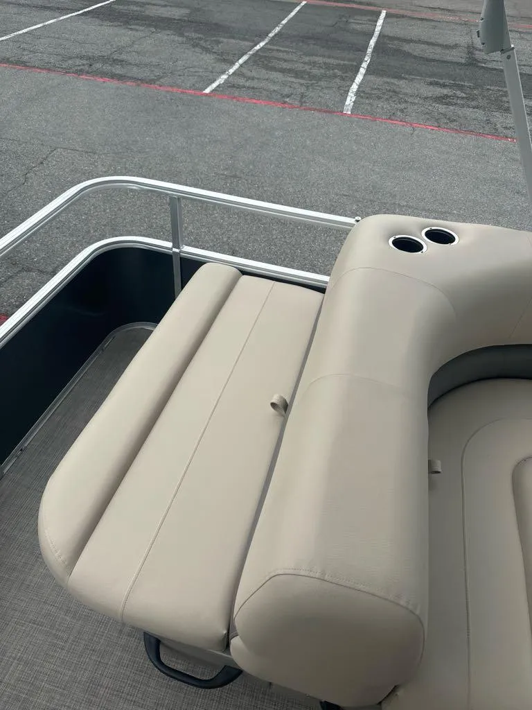 Slide: The Image of 2025 Sun Tracker Party Barge 18 DLX with beige seating and cup holders. - 7