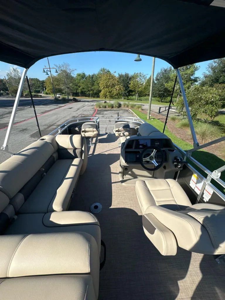 Slide: The Image of 2025 Sun Tracker Fishin' Barge 20 DLX interior with seating and steering console. - 5