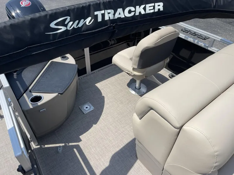 Slide: The Image of 2025 Sun Tracker SportFish 20 DLX interior with beige seating and helm. - 10