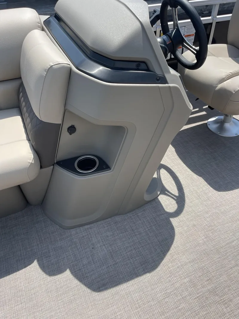 Slide: The Image of 2025 Sun Tracker SportFish 20 DLX boat interior with beige seating and steering console. - 13