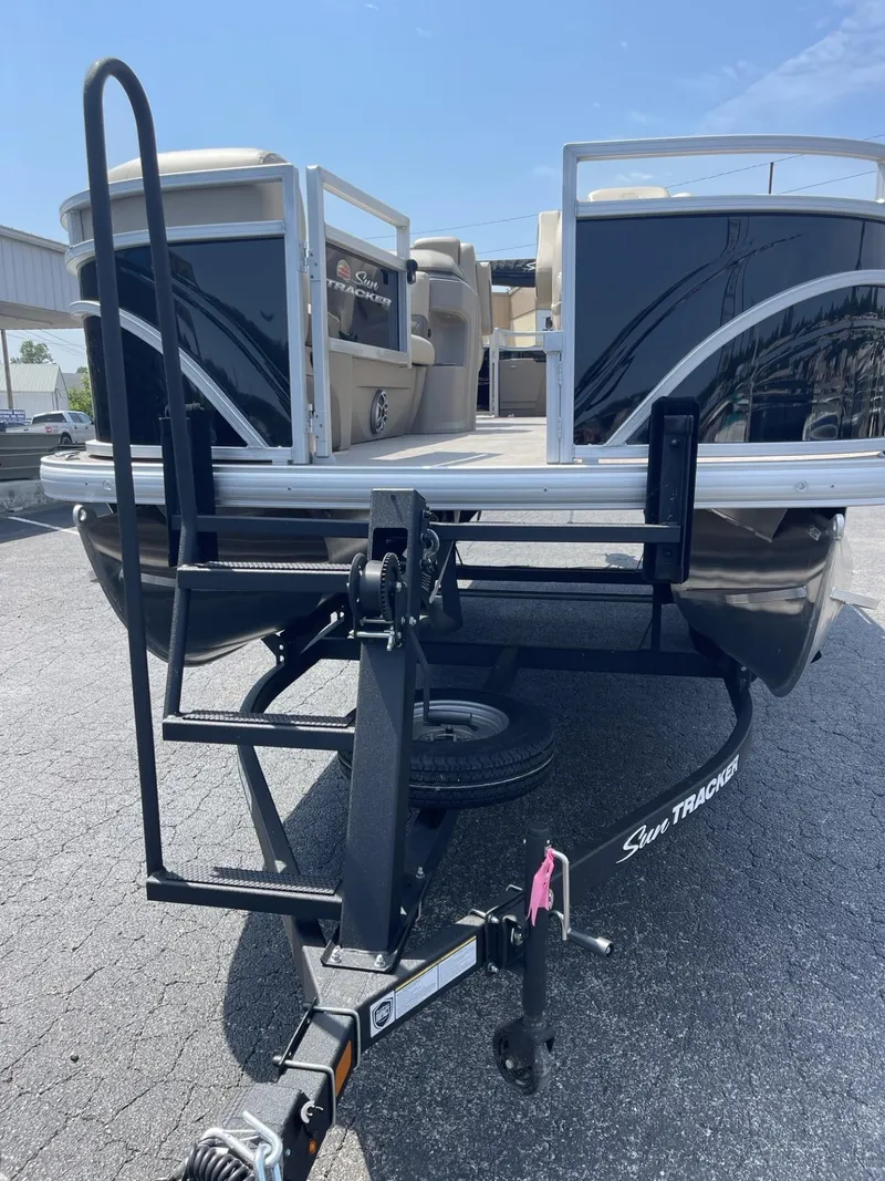 Slide: The Image of 2025 Sun Tracker SportFish 20 DLX pontoon boat on trailer, front view. - 3